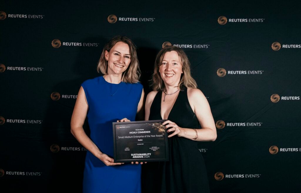 Two women hold an award certificate